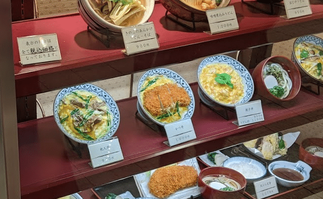 Rice bowls displayed outside of a shop.